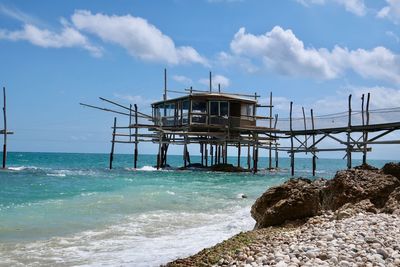 Lifeguard hut on beach against sky