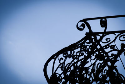 Low angle view of silhouette trees against sky