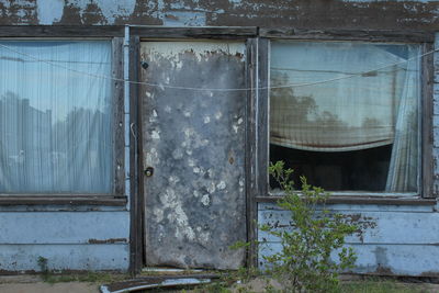 Damaged door in abandoned building