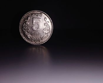 Close-up of coins on black background