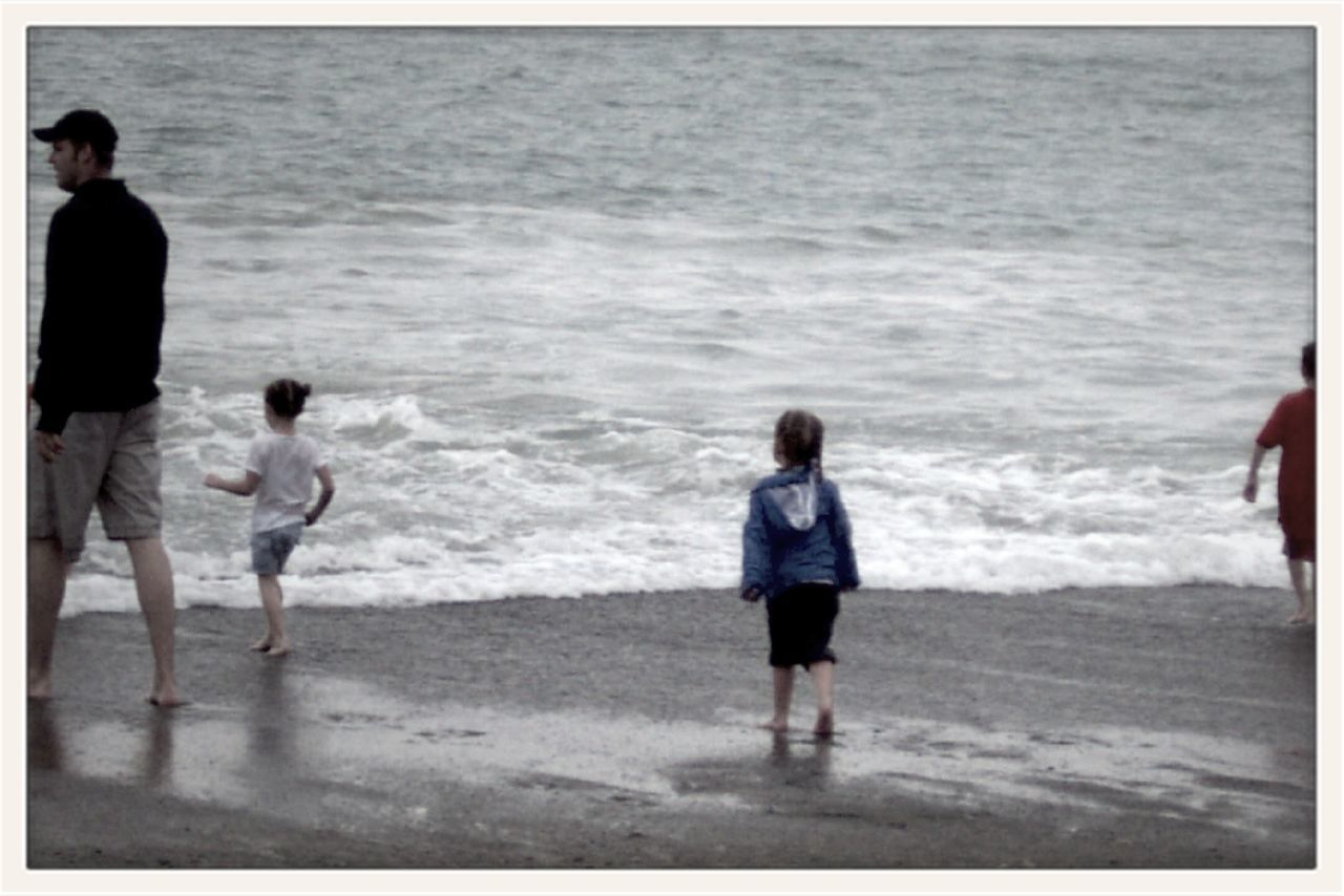 sea, water, beach, shore, transfer print, full length, sand, horizon over water, lifestyles, wave, leisure activity, rear view, auto post production filter, surf, vacations, walking, childhood, standing