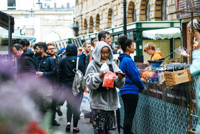 People walking on street in city