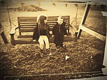 Full length of woman standing on bench