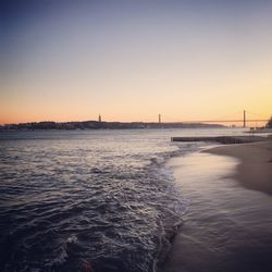 Scenic view of tejo river against clear sky during sunset