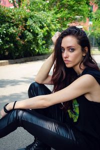 Portrait of young woman sitting outdoors