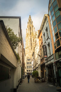 People walking in city against sky