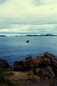 Scenic view of sea against cloudy sky