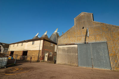 Low angle view of building against clear blue sky