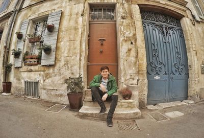 Man standing in front of old building