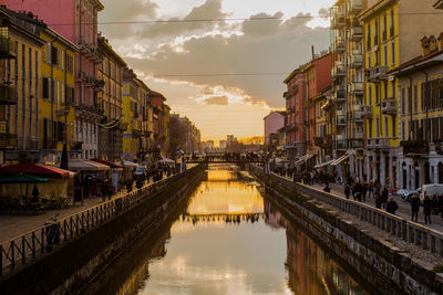 Panoramic view of canal in city against sky