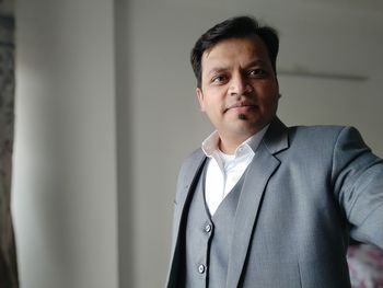 Portrait of businessman standing at home