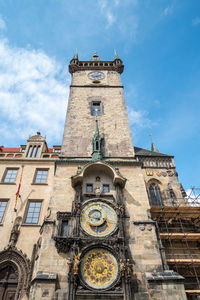 Low angle view of clock tower against sky