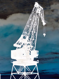Traditional windmill on beach against sky