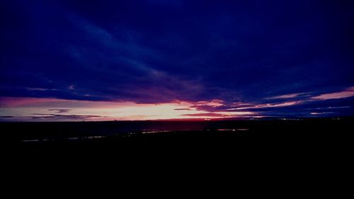 Silhouette landscape against sky at sunset