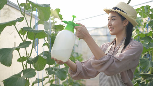 Midsection of woman holding plants