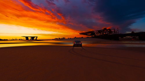 Scenic view of dramatic sky over road during sunset