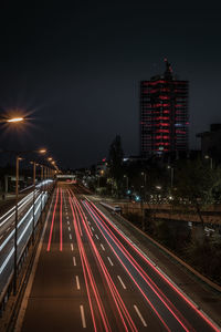 Light trails on road in city at night