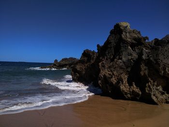 Scenic view of sea against clear blue sky