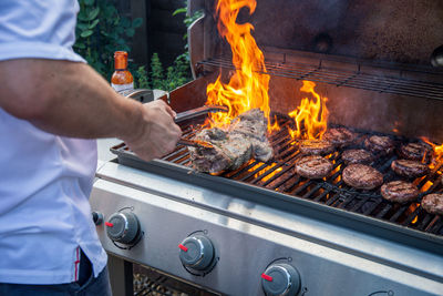 Man preparing food on barbecue grill