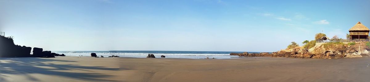 Panoramic view of beach against blue sky