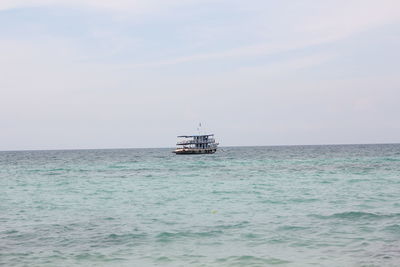 Boat sailing in sea against sky