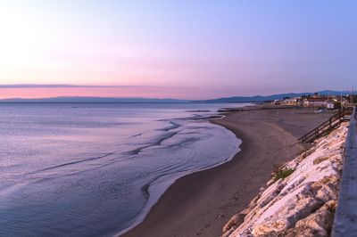 Scenic view of beach against sky during sunset