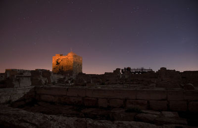 Old ruin building against sky at night