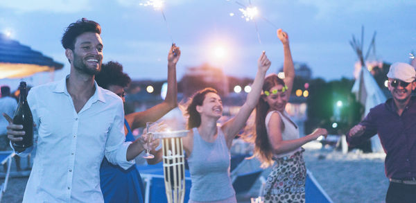 Friends dancing at party during dusk