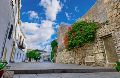 Low angle view of buildings against cloudy sky