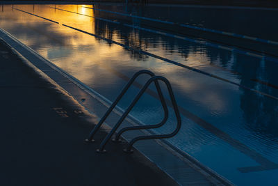 Wet swimming pool at night during rainy season