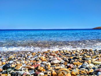 Scenic view of sea against clear blue sky