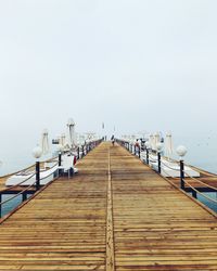 Pier over sea against clear sky