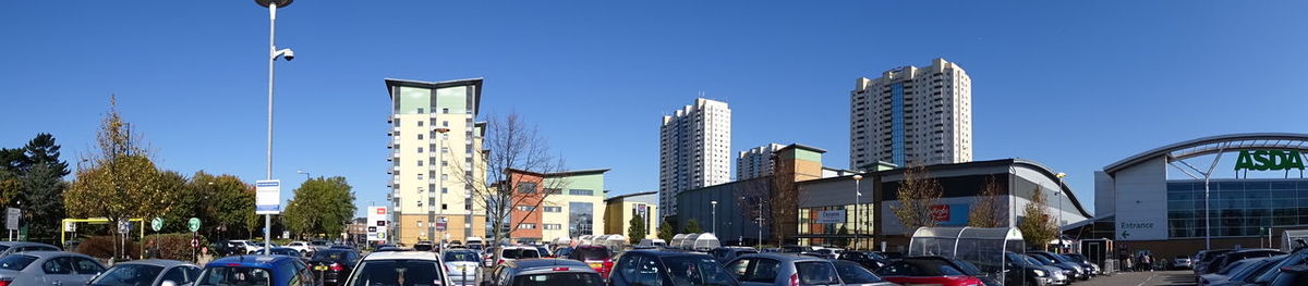 Panoramic view of city street and buildings against sky