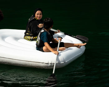 Man and woman in boat on lake