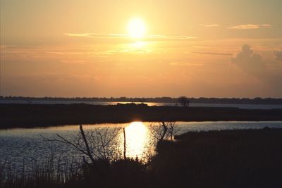 Scenic view of lake at sunset