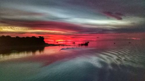 Scenic view of dramatic sky over sea during sunset