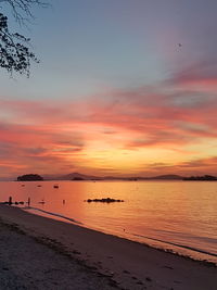 Scenic view of beach against sky during sunset