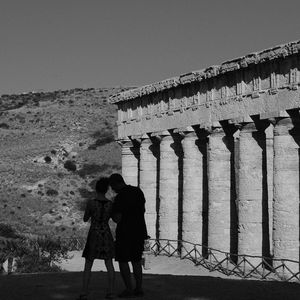 People standing at historical building
