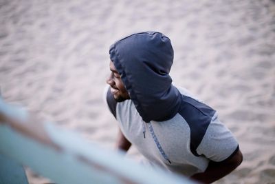 High angle view of man standing on sand at beach