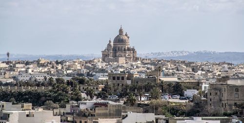 High angle view of buildings in city against sky