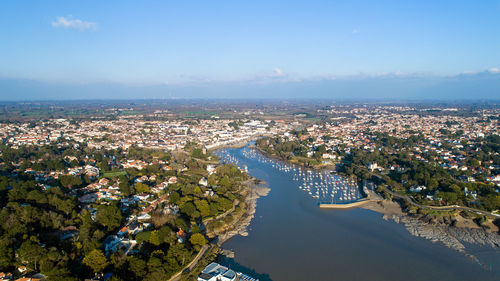 High angle view of river amidst cityscape against sky