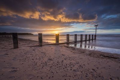 Scenic view of beach at sunset