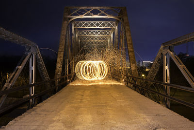 Illuminated bridge at night