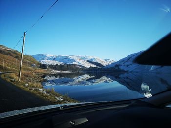 Scenic view of snowcapped mountains against clear blue sky