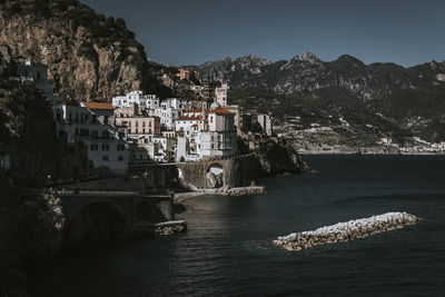 Aerial view of sea and buildings against sky