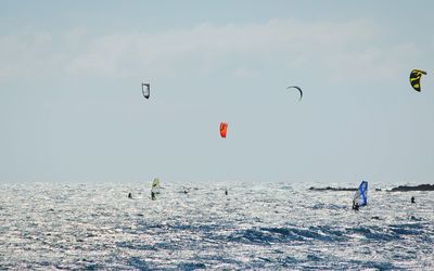 Person paragliding over landscape