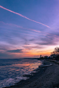 Scenic view of sea against romantic sky at sunset