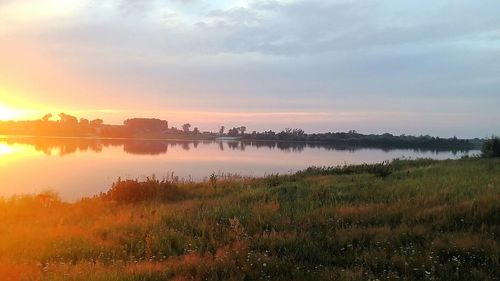 Scenic view of lake against sky during sunset