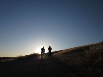 Silhouette of woman against clear sky