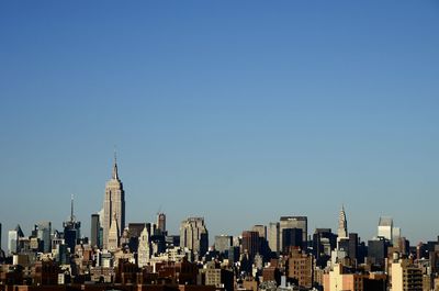 High angle view of cityscape against blue sky